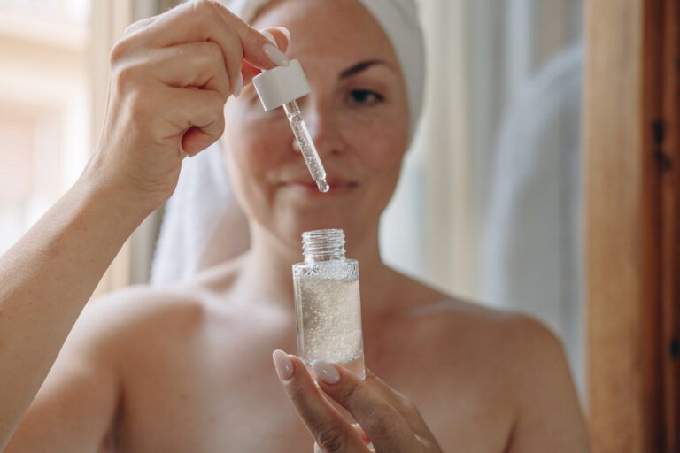 Woman applying daily skin care after a shower