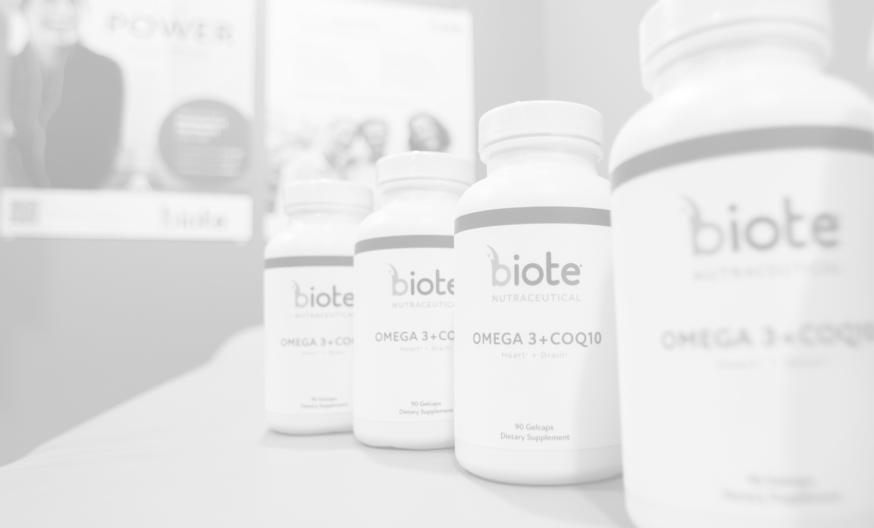 There are multiple white bottles lined up, prominently displaying the